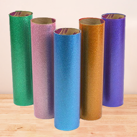 Galaxy Stretchable Glitter HTV rolls, showcasing smooth finishes and vibrant glitter particles, perfect for dark-colored garments.