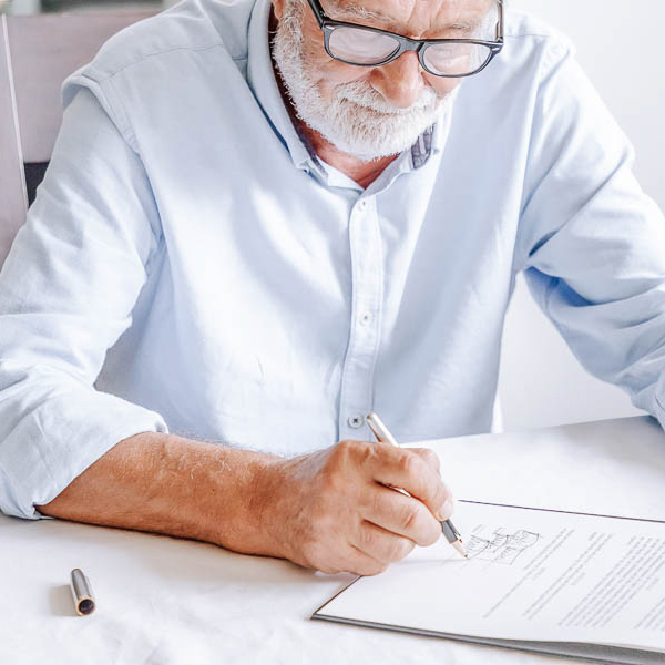 man signing papers