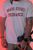 Model wearing the Brass Kisses Ordnance Tee — military-inspired collegiate graphic tee styled in an athletic tapered fit.