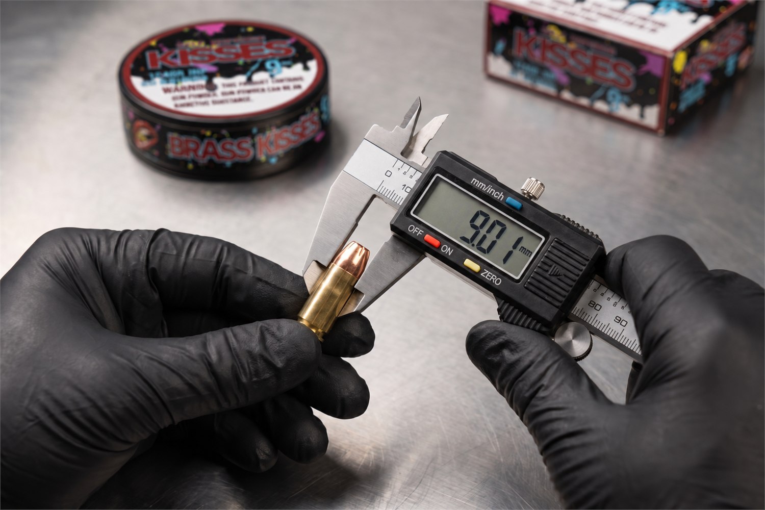 Digital caliper measuring a 9mm cartridge at 9.01mm during quality control