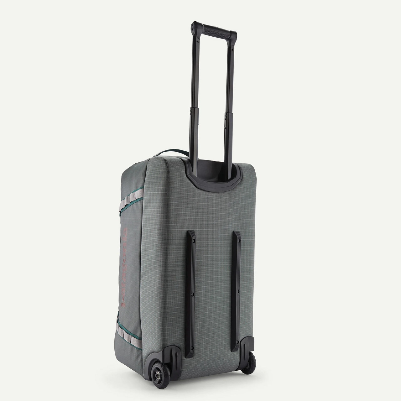 Patagonia Black Hole Wheeled Duffel 70L, gray travel duffel bag with a retractable handle and four wheels for easy mobility.