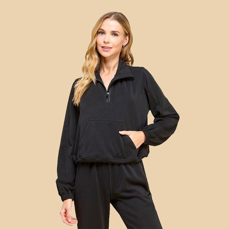 TCEC Women's Mock Neck Sweatshirt, black athletic pullover with zip collar and kangaroo pocket worn by a woman.