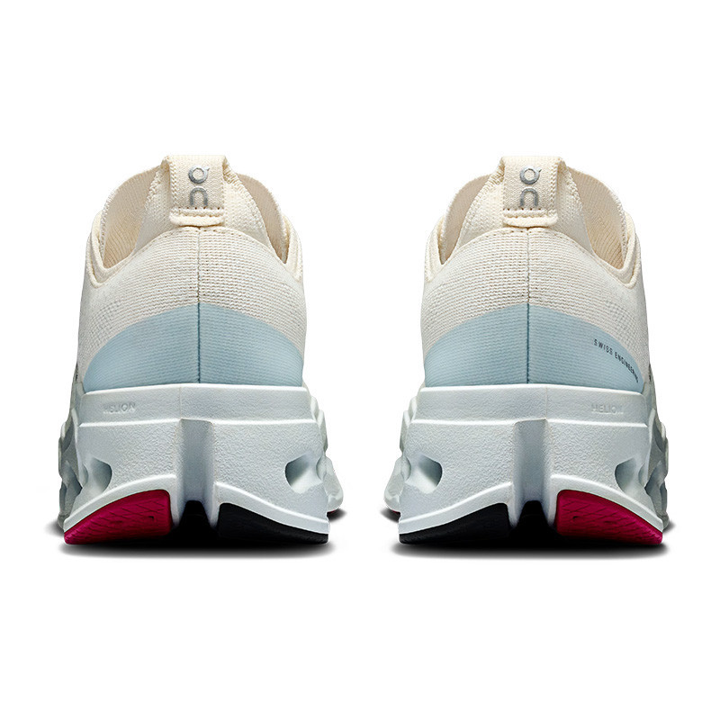 On Women's Cloudsurfer Max 1 Running Shoes, rear view of the lightweight athletic sneakers with cushioned soles and breathable fabric uppers in beige and light blue, designed for running and active wear.