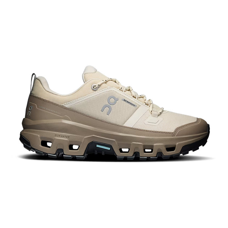 On Women's Cloudrock Low Waterproof Hiking Shoes, light beige outdoor trail footwear with waterproof features and rugged sole for hiking.