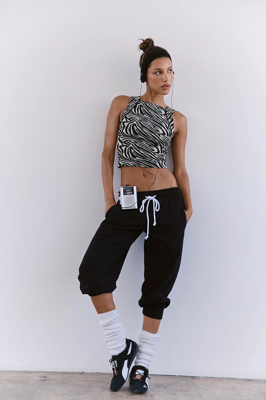 FP Movement Women's Flutter Jogger, black relaxed fit cropped joggers with white drawstring and cuffs.