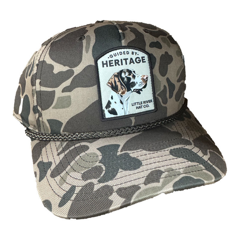 Little River Hat & Clothing Co. Little River Guided By Heritage Hat, camouflage baseball cap with a patch featuring a Dalmatian dog and the text 'Guided By Heritage'.