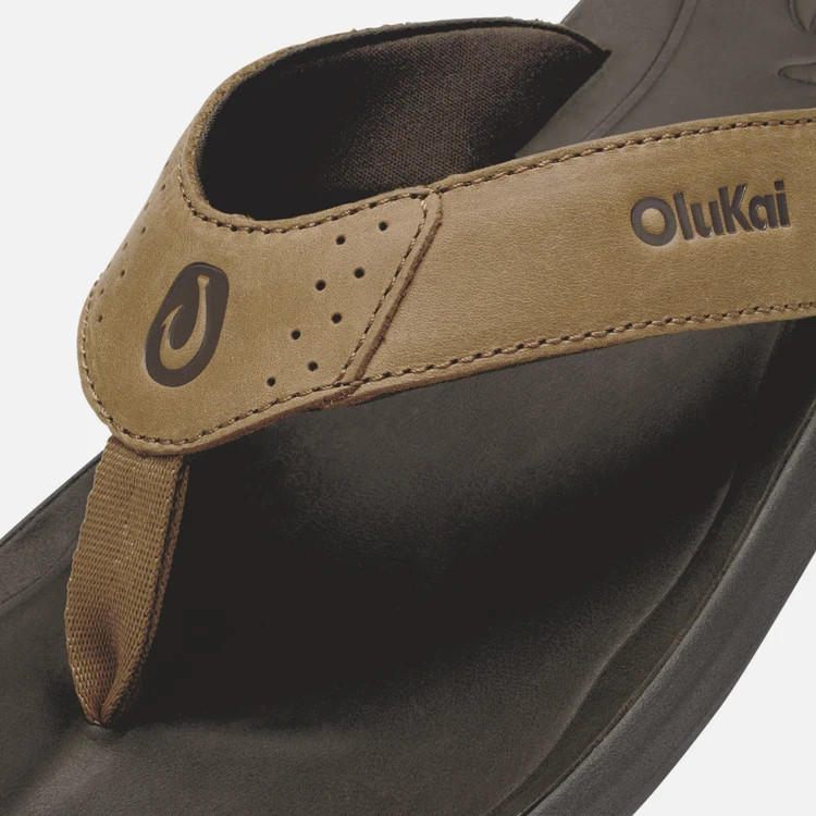 Olukai OluKai Men's Pili Sandal, close-up of tan and black sandal with adjustable strap and logo detail