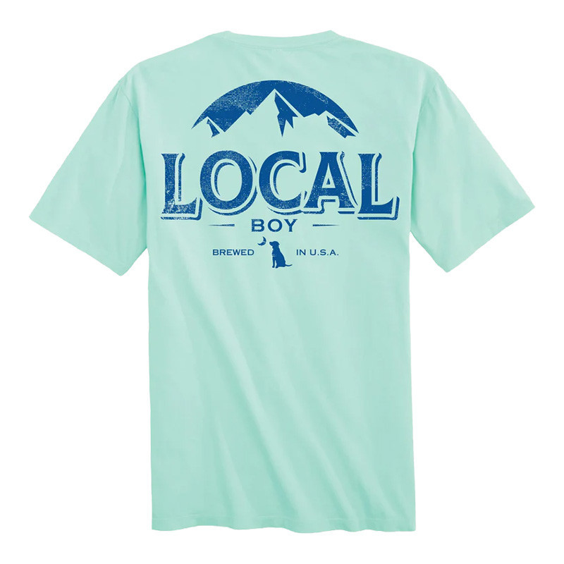 Local Boy Distressed Latte SS Tee, front view of a light latte-colored T-shirt with a blue graphic design featuring mountains, the words 'LOCAL BOY' and 'BREWED IN U.S.A.'