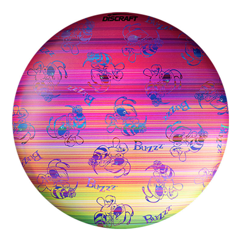 Discraft Full Foil SuperColor Buzzz Swarm, colorful disc golf disc with a rainbow gradient background featuring multiple Buzzz bee illustrations and the Discraft logo.