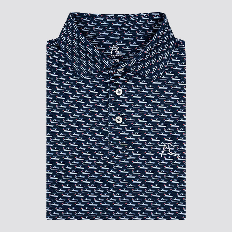 Rhoback Men's The Skipper Performance Polo, navy blue polo shirt with a nautical boat pattern and a small Rhoback logo embroidered on the chest.