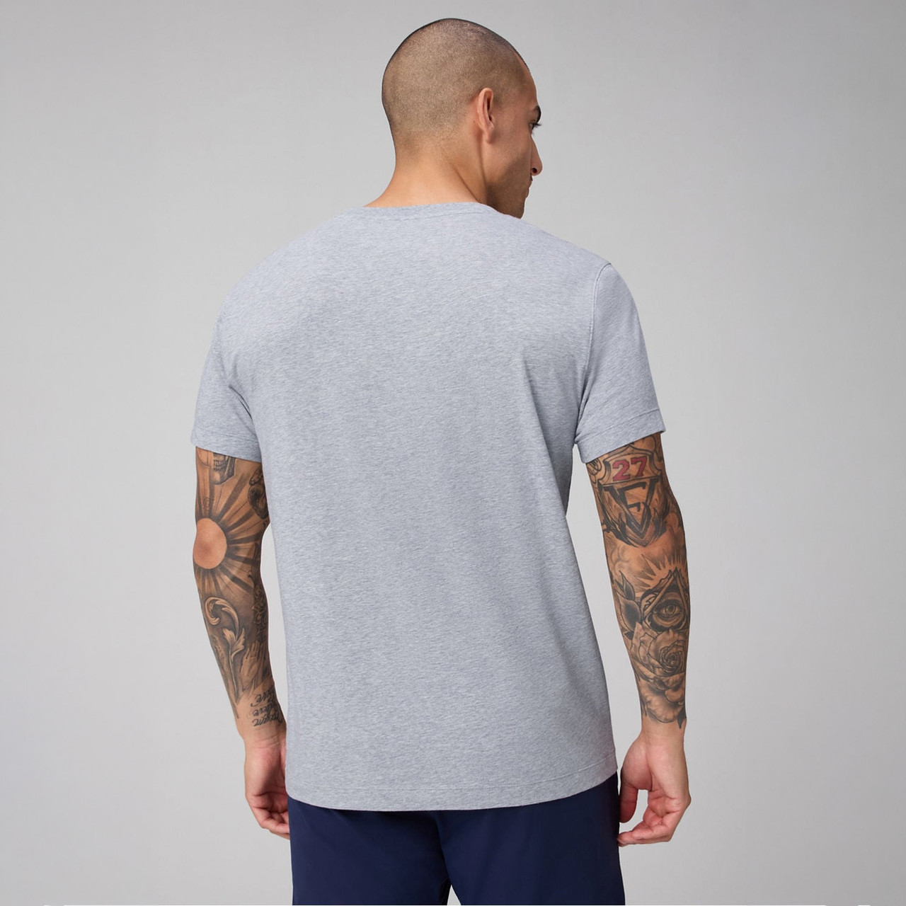 Fabletics Men's 24-7 Tee, back view of a man wearing a light gray athletic t-shirt.