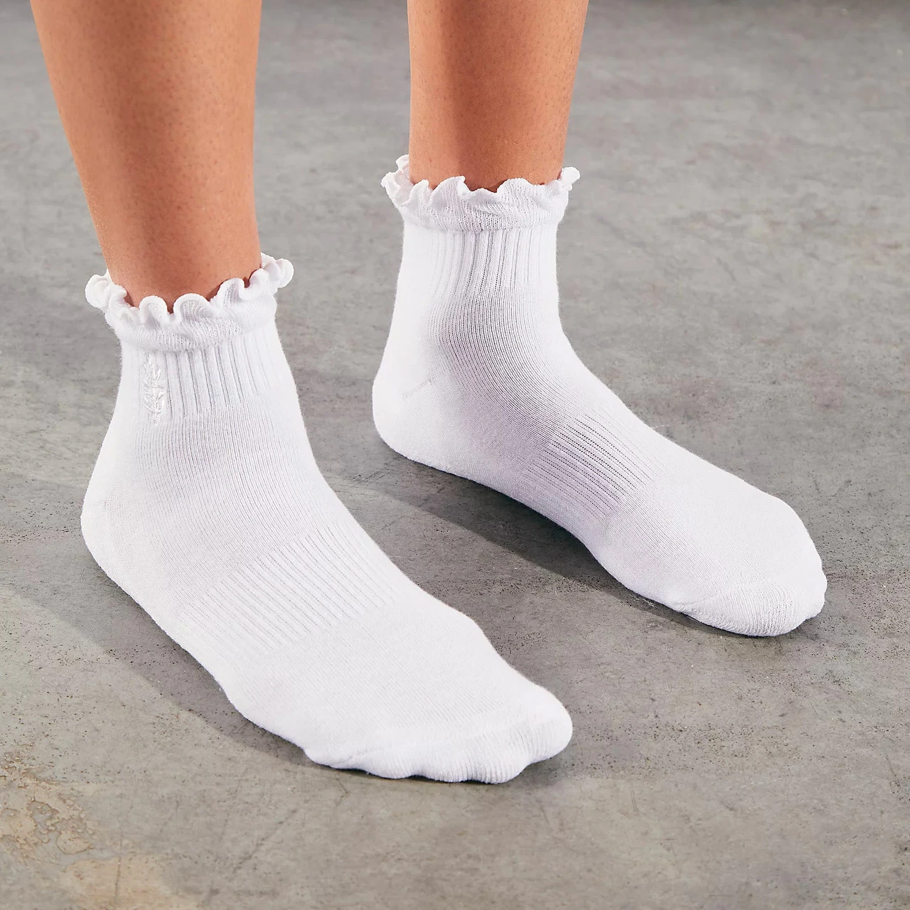 FP Movement Women's Classic Ruffle Sock, white ankle socks with ruffled trim at the top and ribbed knit design.