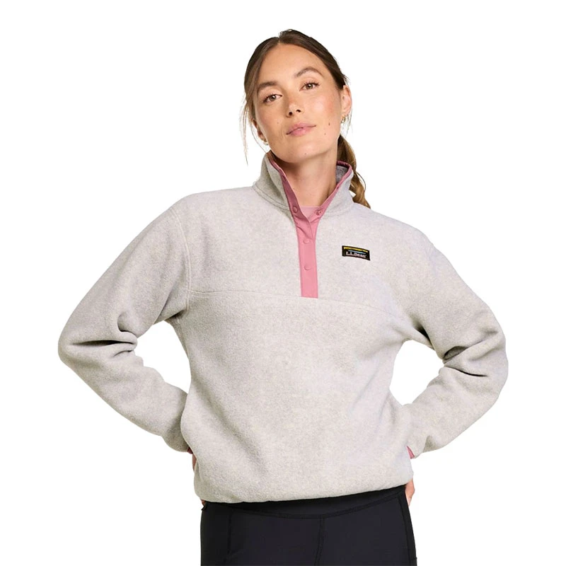 L.L.Bean Women's Mountain Classic Fleece Pullover, woman modeling a light gray fleece pullover with a pink snap placket and stand collar against a white background.