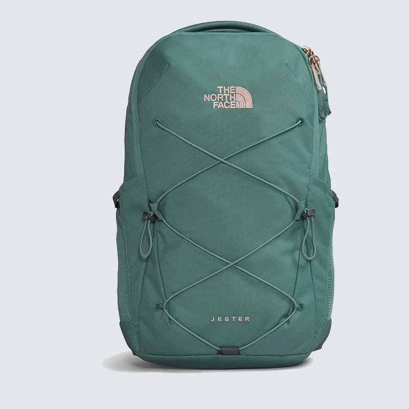 The North Face Women's Jester backpack, green color with adjustable bungee cords and multiple compartments for storage.