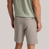 Free Fly Men's Tradewind Short, beige casual shorts with back welt pockets and a small logo patch on the waistband.