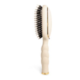 Teleties Boar Bristle Hair Brush, elegant off-white hair brush with black bristles and gold accents, designed for gentle detangling and grooming of hair.