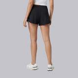 Vuori Women's Clementine 2.0 Short - 4" Inseam, black athletic shorts worn by a model from the back