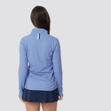 Rhoback Women's Mirage Performance Q-Zip, back view of a woman wearing a blue and white patterned quarter-zip athletic top with a high collar and reflective detailing on the back.