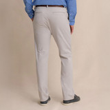 Southern Tide Men's Jack Performance Pant - 32" Inseam, back view of beige men's dress pants worn by a person against a plain background.