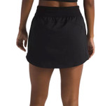 The North Face Women's Aphrodite Arise Skort, black athletic skort worn by a model showing the back view with an elastic waistband and skirt overlay.