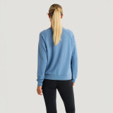 Free Fly Women's Bamboo Lightweight Fleece Crew, back view of a woman wearing a light blue fleece sweatshirt with long sleeves and a relaxed fit.