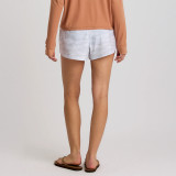 Free Fly Apparel Free Fly Women's Bamboo-Lined Active Breeze Short - 3" Inseam, woman wearing white bamboo-lined active shorts with a subtle camo pattern, paired with a peach long sleeve top and flip flops.