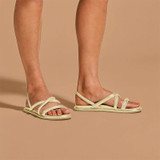 Olukai Women's Tiare Strappy Sandals, lightweight and stylish cream-colored sandals with multiple straps and a flat sole.