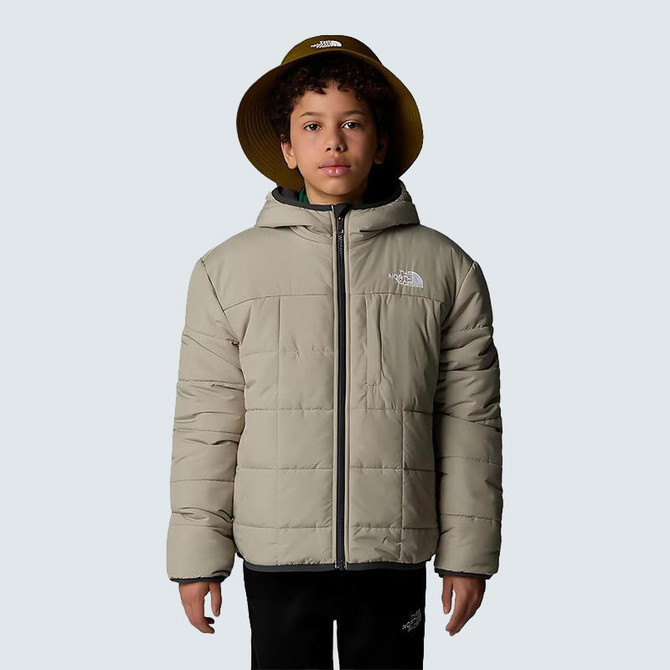Summer Sale exclusions The North Face Boys' Reversible Shasta Full-Zip Hooded Jacket, a young boy wearing a beige, puffy, reversible jacket with a hood and North Face logo, standing against a plain background.