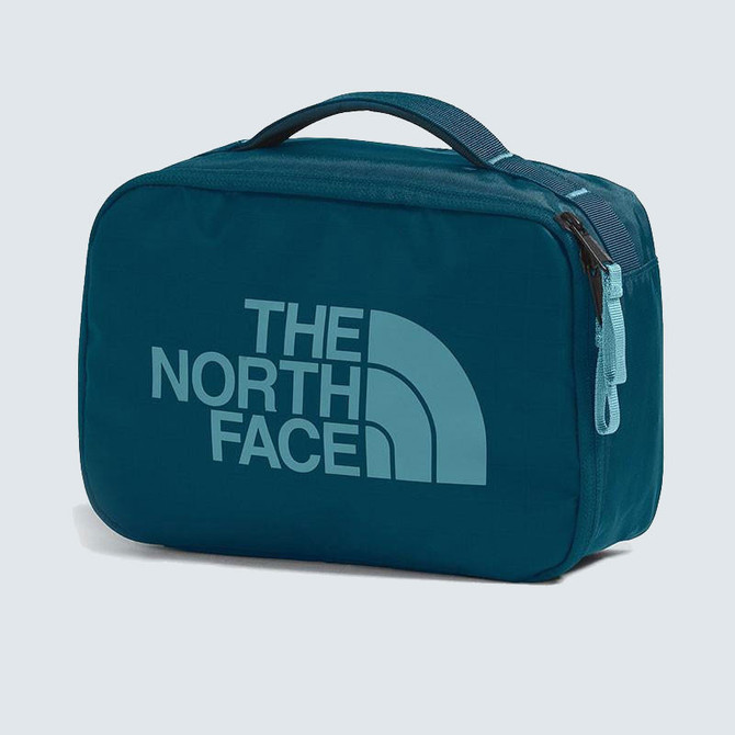 The North Face Base Camp Voyager Dopp Kit, blue travel toiletry bag with handle and zipper closure featuring the brand's logo.