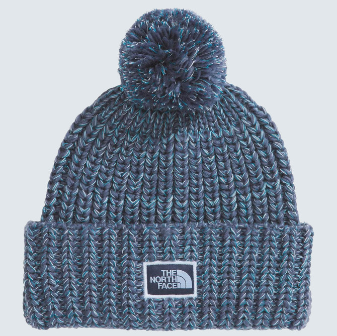 Summer Sale exclusions The North Face Cozy Chunky Cabin Beanie, knitted navy blue beanie with a pom-pom on top and The North Face logo patch on front.