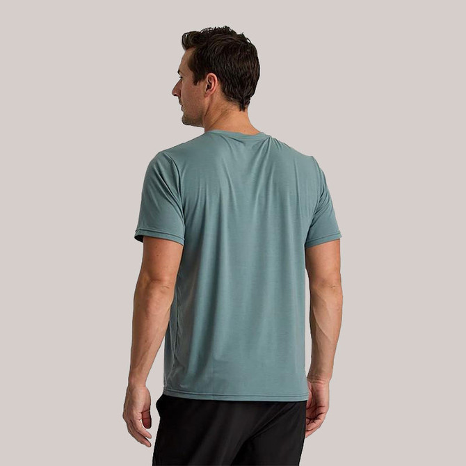 Free Fly Apparel Free Fly Men's Short Sleeve Elevate Lightweight Tee, back view of a man wearing a light blue short sleeve athletic t-shirt.