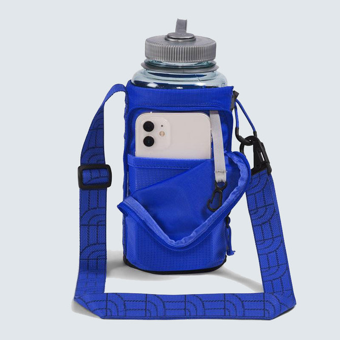 The North Face Borealis Water Bottle Holder, a compact blue water bottle holder with a built-in pocket for a smartphone and an adjustable strap for easy carrying.
