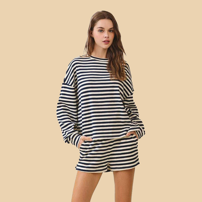 TCEC Women's Striped Boxy Long Sleeve Top, a woman wearing a navy and white striped long sleeve top with a boxy fit paired with matching striped shorts against a beige background.