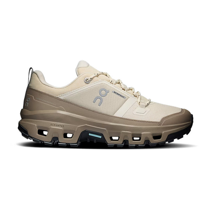 On Women's Cloudrock Low Waterproof Hiking Shoes, light beige outdoor trail footwear with waterproof features and rugged sole for hiking.