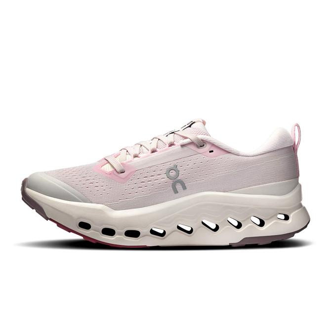 On Running Women's Cloudsurfer Trail 2, pink and white trail running shoe with cushioned sole and breathable mesh upper.