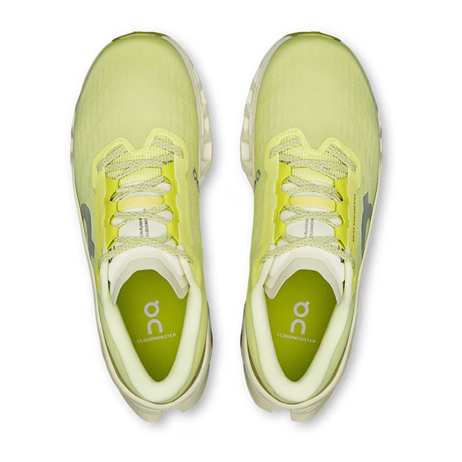 On Running Women's Cloudmonster 3, top view of bright yellow running shoes with cushioned soles and breathable mesh material.