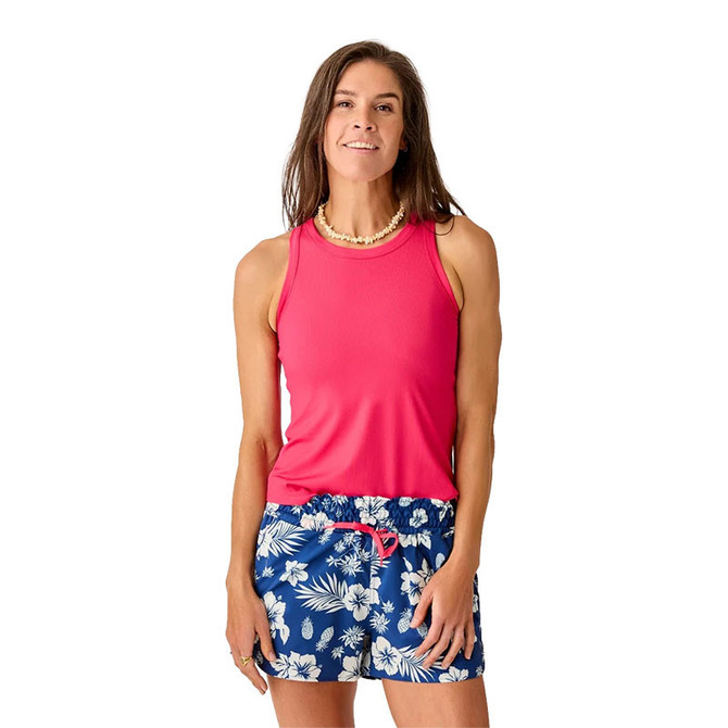 Carve Designs Carve Women's Lyra Rib Tank, a woman wearing a bright pink sleeveless ribbed tank top paired with blue floral shorts.