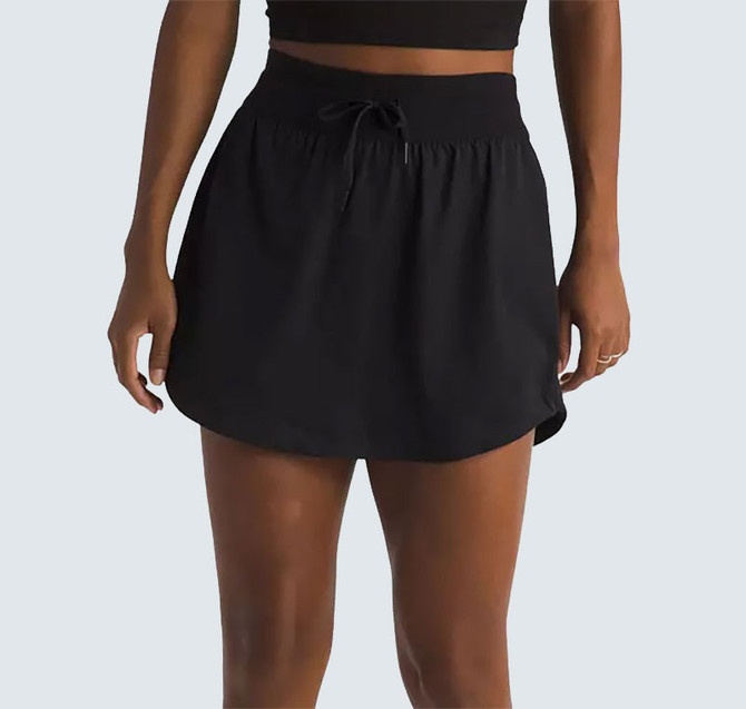 The North Face Women's Aphrodite Arise Skort, black athletic skort with a drawstring waistband and built-in shorts, ideal for running and outdoor activities.