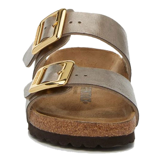 Birkenstock Sandals Birkenstock Sydney Luxe Buckle Sandal, close-up view of the beige double-strap sandal with gold buckles, cushioned footbed, and cork sole.