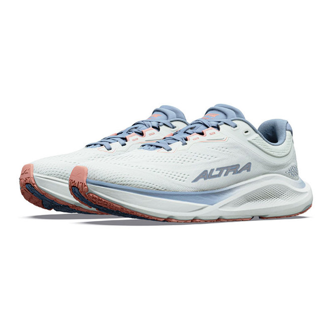 Altra Women's Torin ST, running shoes in white, light blue, and peach color with breathable mesh upper and cushioned sole.