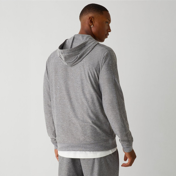 Fabletics The Cloud Jersey Hoodie, a man wearing a light gray hoodie with a subtle textured pattern, showing the back view.