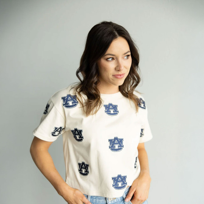 Gameday Social Apparel Gameday Social Women's Auburn Ritter Repeat Heavyweight Tee, a woman wearing a white heavyweight t-shirt with navy blue Auburn logo print.