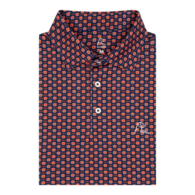Rhoback Men's Auburn National Titles Performance Polo, navy short-sleeve polo shirt with an all-over orange and blue Auburn championship pattern, button placket, and embroidered logo.