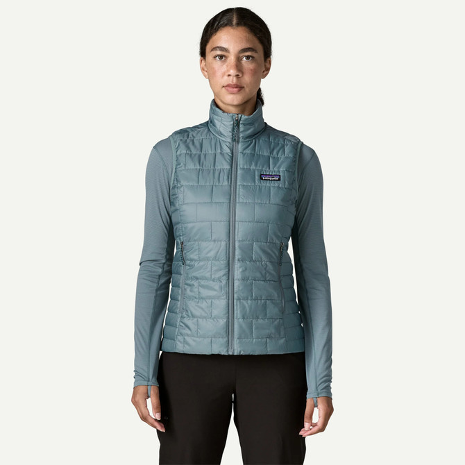 Patagonia Women's Nano Puff Vest, blue lightweight insulated puffer vest on a female model.