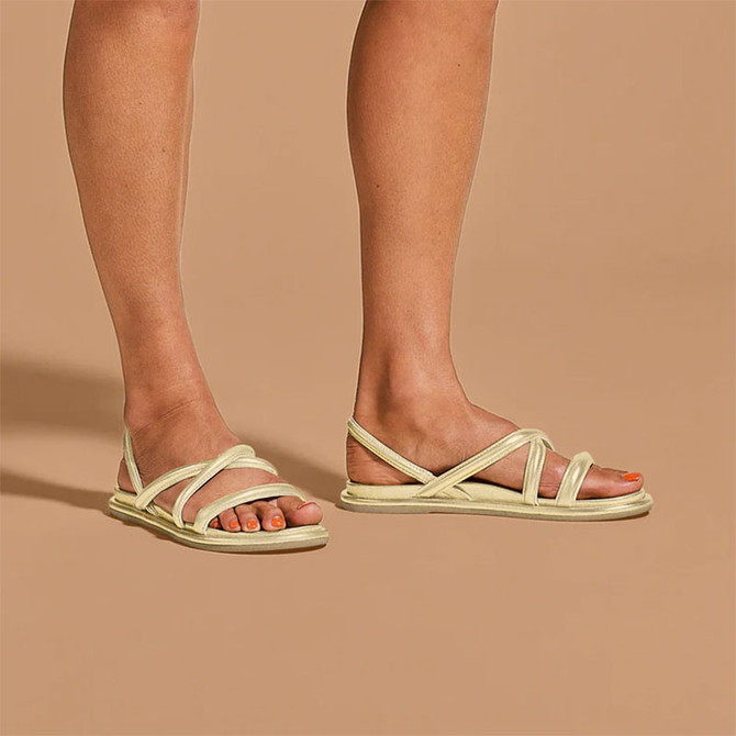 Olukai Women's Tiare Strappy Sandals, lightweight and stylish cream-colored sandals with multiple straps and a flat sole.