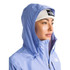 The North Face Women's Venture 2 Jacket, a light blue waterproof outdoor jacket with a hood, worn by a woman with a white beanie showing from underneath.