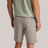 Free Fly Men's Tradewind Short, beige casual shorts with back welt pockets and a small logo patch on the waistband.