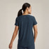 Beyond Yoga Women's Featherweight On The Down Low T-Shirt, back view of a woman wearing a navy blue lightweight casual T-shirt with a small logo at the upper back