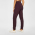 Fabletics Women's Cloud Jersey Jogger, purple lounge pants with a relaxed fit and comfortable elastic waistband, worn with white sneakers.