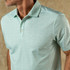Duck Head Men's Short Sleeve Long Drive Performance Polo - Bay Floral, light blue polo shirt with a subtle floral pattern for men, featuring a collar and button placket.